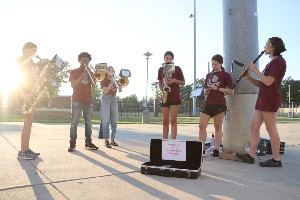 Band members rehearsing with instruments.