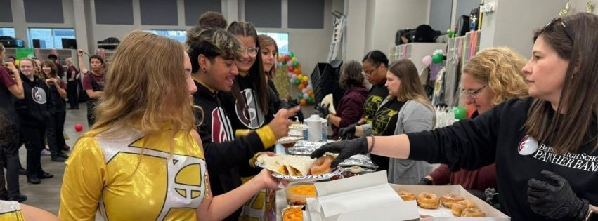 People serving Benton Band students before State competition.